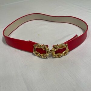 red leather belt with a gold-tone chainlink buckle